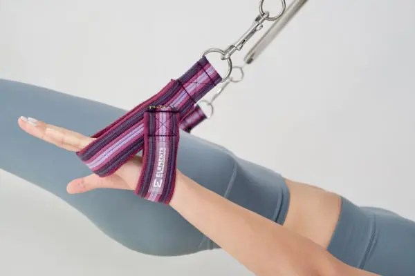 Small Y loop straps in use on Pilates Cadillac, purple rainbow