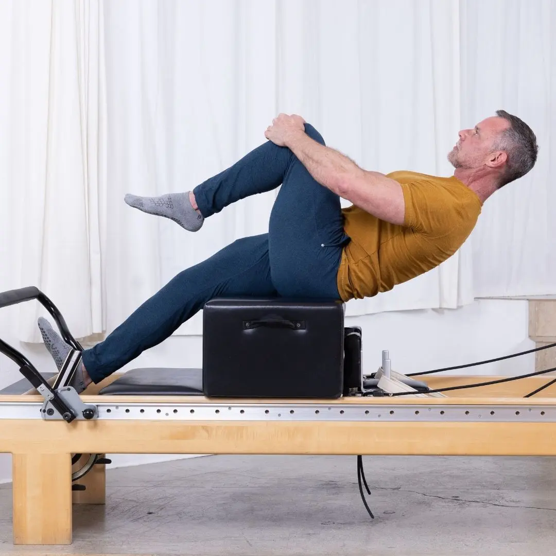 Pilates instructor Sean Bergara training with ELEMENTS Safety Foot Strap on Reformer