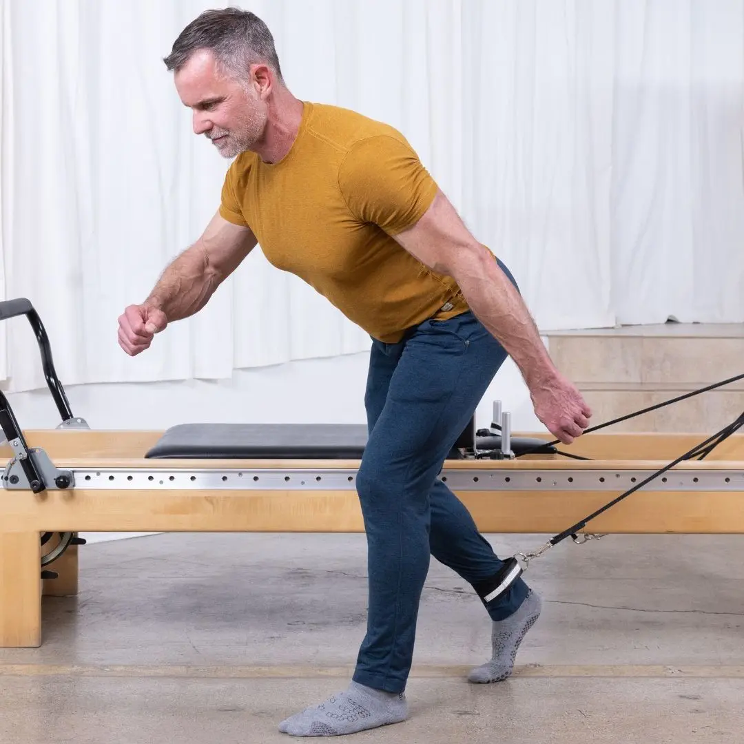 Sean Bergara demonstrating Pilates exercises with ELEMENTS Jumbo Straps on a Reformer