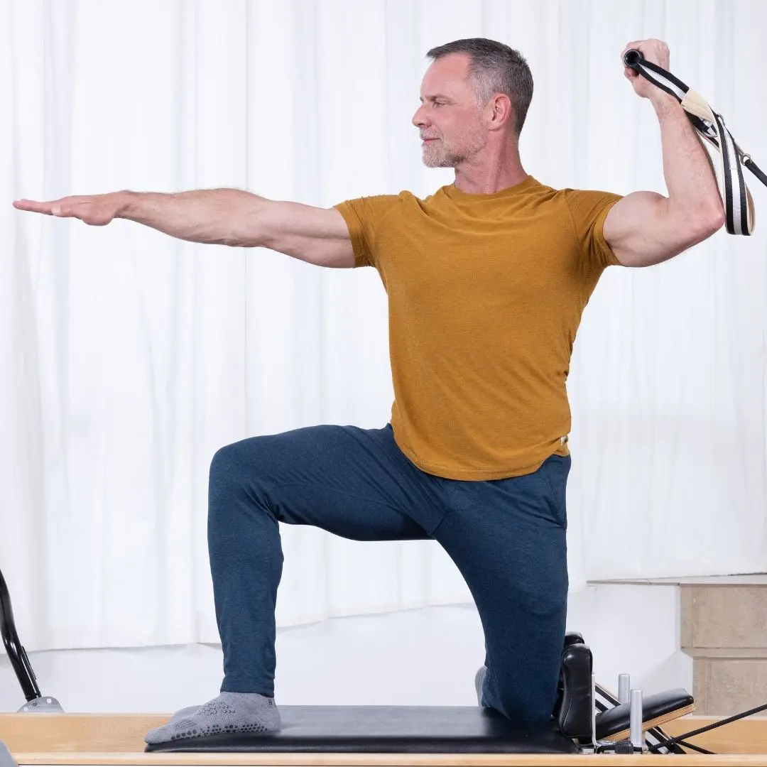 Sean Bergara practising Pilates on Reformer with ELEMENTS Roll Handles
