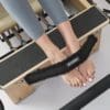 Pilates safety foot strap black faux fur in use