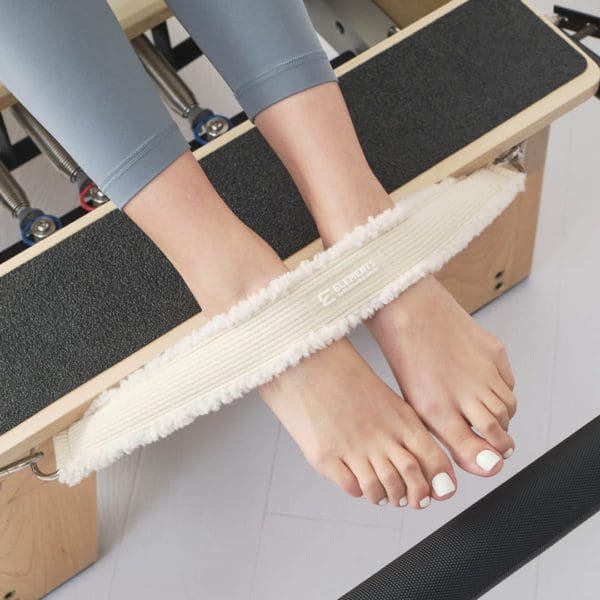 Reformer safety foot strap ivory faux fur in use